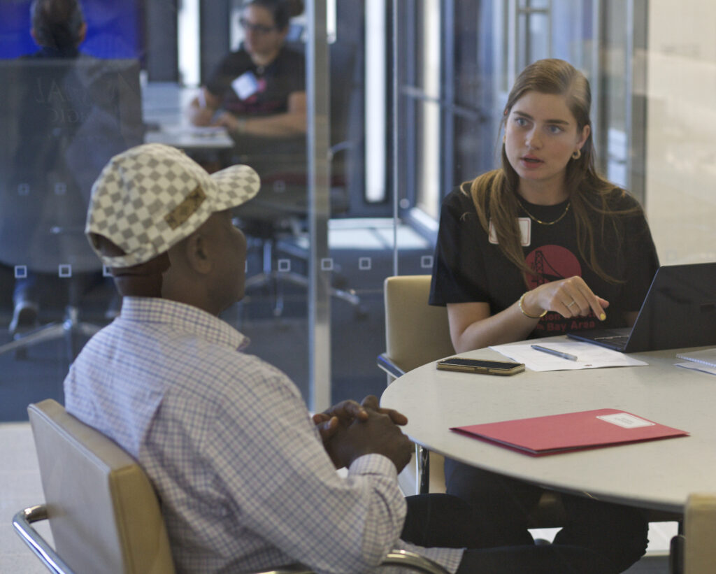 IIBA volunteer helps a client at immigration legal services clinic.