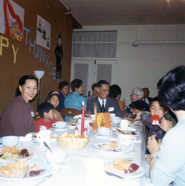 Immigrants at Thanksgiving table.