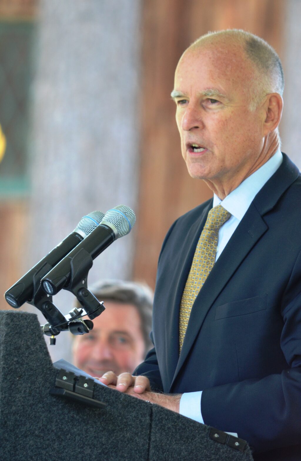 Jerry Brown at a podium speaking.