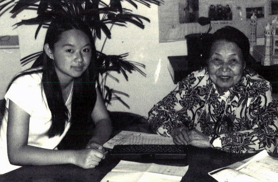 Two women sitting at table.